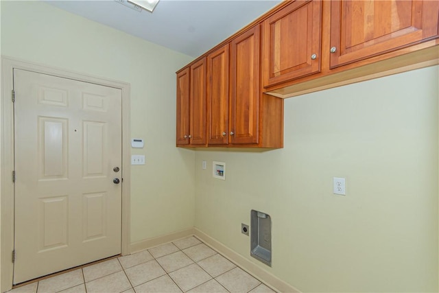 clothes washing area featuring cabinets, hookup for an electric dryer, light tile patterned floors, and washer hookup