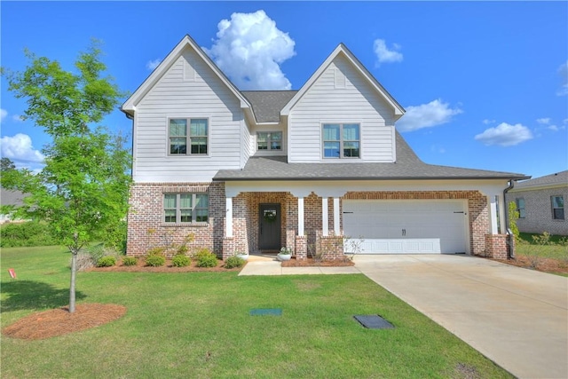 view of front of property featuring brick siding, a front yard, concrete driveway, and a shingled roof