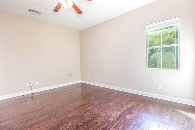 empty room featuring a ceiling fan, wood finished floors, and baseboards
