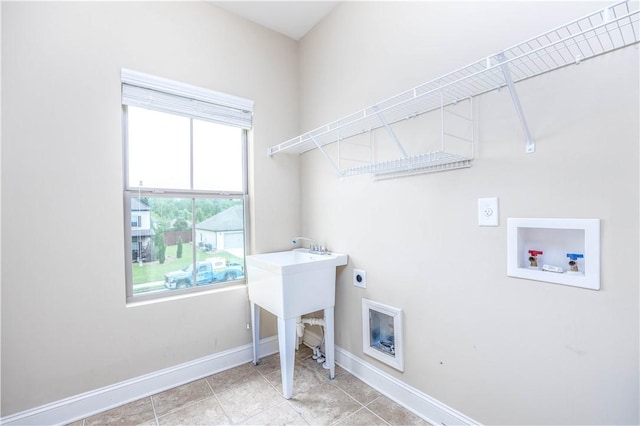 laundry area with hookup for an electric dryer, hookup for a washing machine, baseboards, and light tile patterned floors