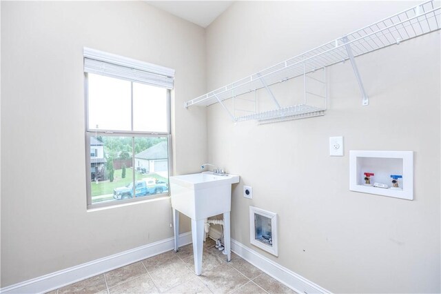 laundry room with hookup for an electric dryer, washer hookup, baseboards, and light tile patterned floors