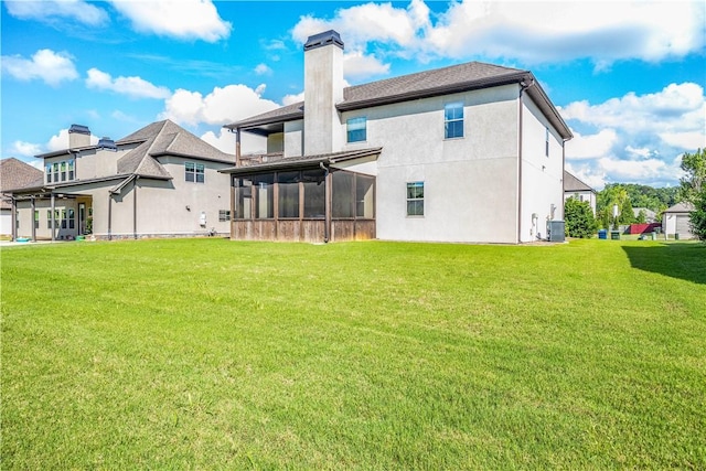 167 Vinci Way, Auburn, AL 36830 - back of property featuring a sunroom, a chimney, a yard, and stucco siding