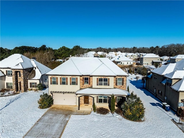 view of front of property with a garage, a residential view, and driveway