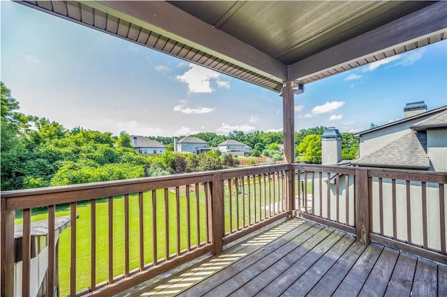 wooden terrace with a yard and a residential view