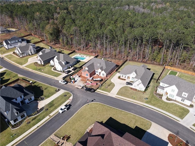 birds eye view of property featuring a forest view and a residential view