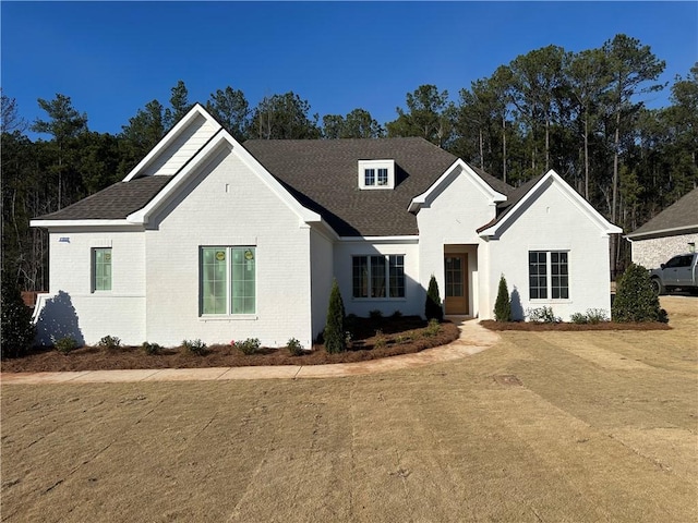 view of front of property with brick siding and a front lawn