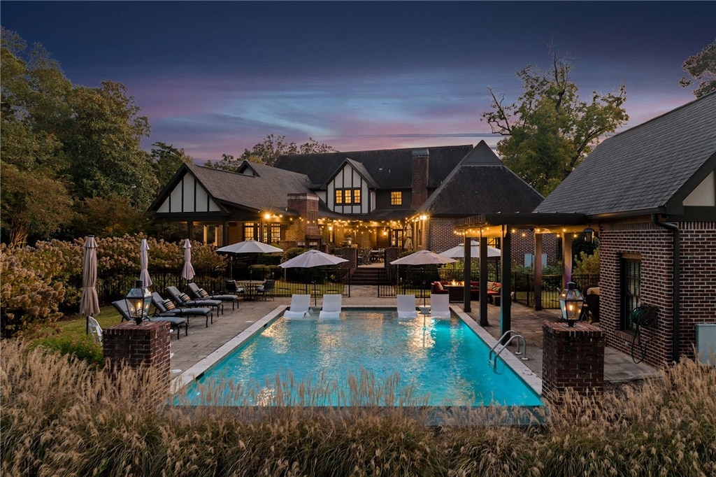 1001 N 10th St, Opelika, AL 36801 - pool at dusk featuring a patio area
