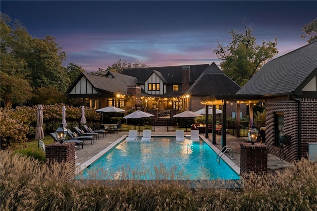 1001 N 10th St, Opelika, AL 36801 - pool at dusk featuring a patio area