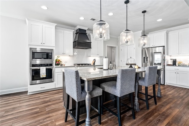 kitchen with visible vents, dark wood-style flooring, custom range hood, appliances with stainless steel finishes, and backsplash
