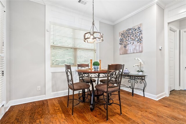 4164 Creekview Ct, Auburn, AL 36832 - dining room featuring a chandelier, wood finished floors, and crown molding