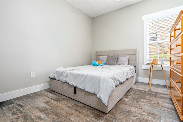 303 N Ross St Unit 104, Auburn, AL 36830 - bedroom with wood finished floors and baseboards