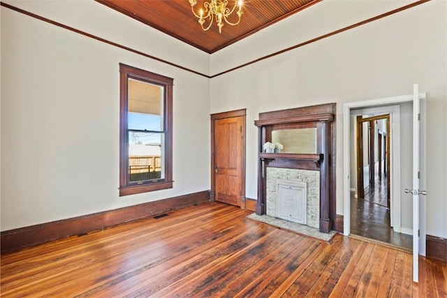 interior space with hardwood / wood-style flooring, wooden ceiling, and a chandelier