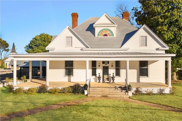 view of front of home featuring a front yard and a porch