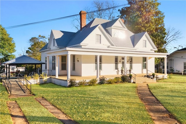 view of front of home featuring a gazebo, covered porch, and a front yard