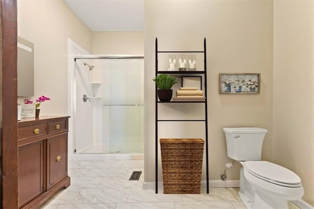 bathroom featuring an enclosed shower and toilet