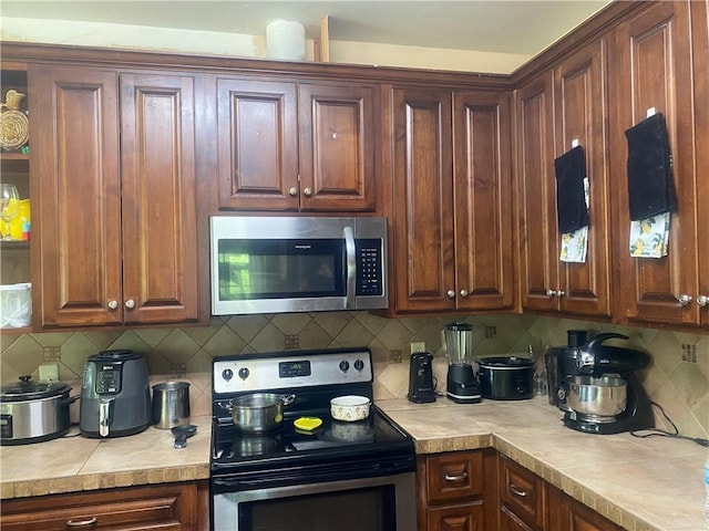 kitchen featuring decorative backsplash and appliances with stainless steel finishes