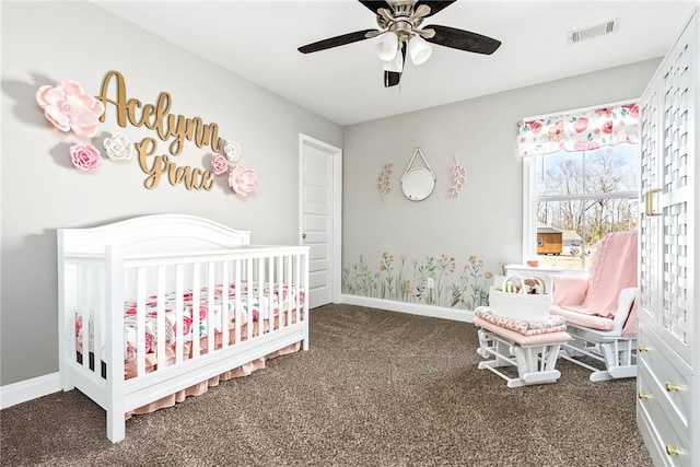 bedroom with carpet flooring, a ceiling fan, visible vents, baseboards, and a nursery area