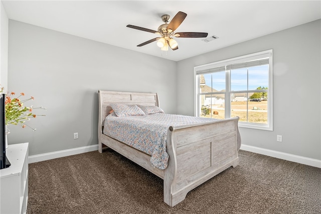 bedroom featuring baseboards, visible vents, dark colored carpet, and a ceiling fan