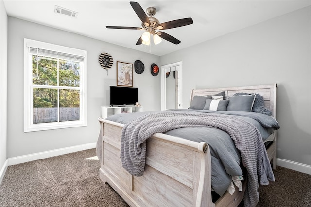 carpeted bedroom with baseboards, visible vents, and ceiling fan