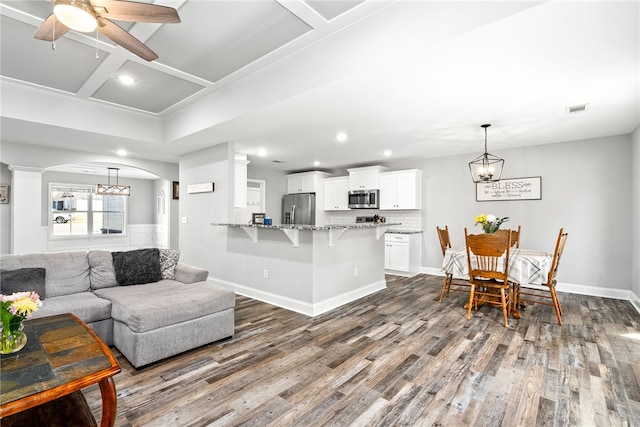 living area with recessed lighting, coffered ceiling, visible vents, baseboards, and dark wood-style floors