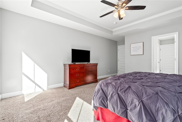 bedroom with a raised ceiling, ornamental molding, carpet flooring, ceiling fan, and baseboards