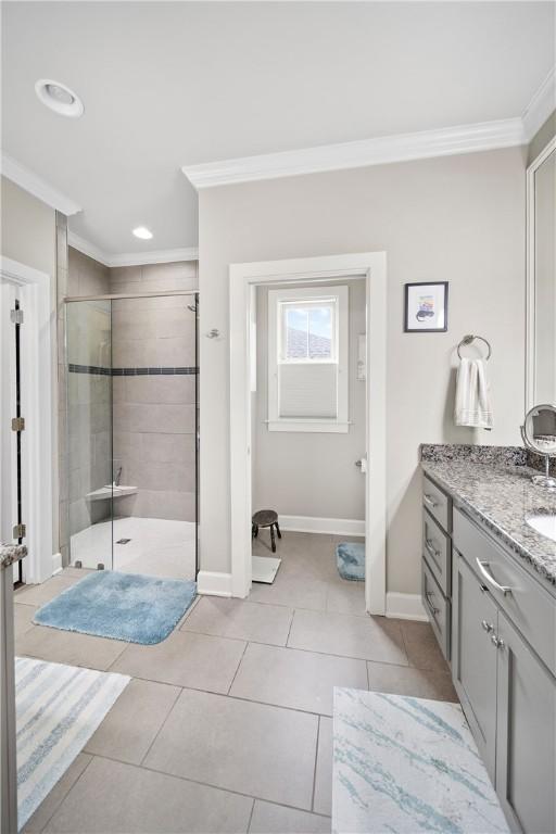 3412 Double Eagle Ln, Opelika, AL 36801 - full bath with ornamental molding, a shower stall, vanity, tile patterned flooring, and baseboards