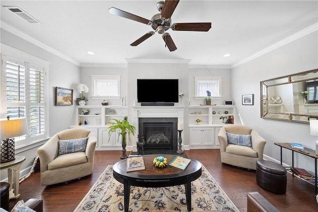 3412 Double Eagle Ln, Opelika, AL 36801 - living area with dark wood-style floors, healthy amount of natural light, a fireplace with flush hearth, ornamental molding, and recessed lighting