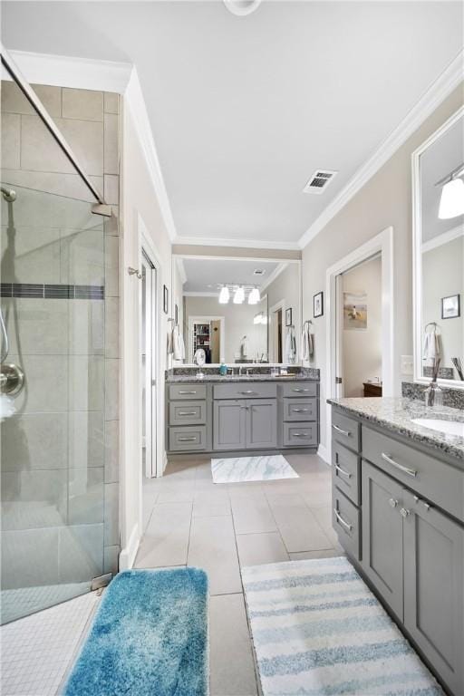 3412 Double Eagle Ln, Opelika, AL 36801 - bathroom featuring a stall shower, ornamental molding, two vanities, and tile patterned floors