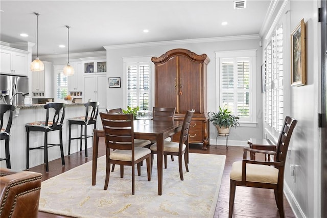 3412 Double Eagle Ln, Opelika, AL 36801 - dining space featuring healthy amount of natural light, dark wood-style floors, crown molding, baseboards, and recessed lighting