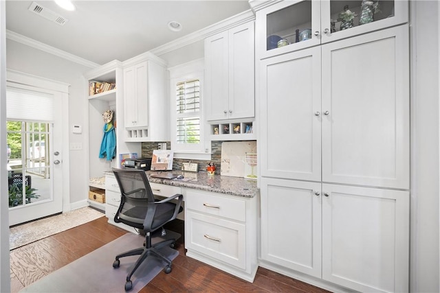 3412 Double Eagle Ln, Opelika, AL 36801 - home office featuring built in study area, crown molding, dark wood-type flooring, and baseboards