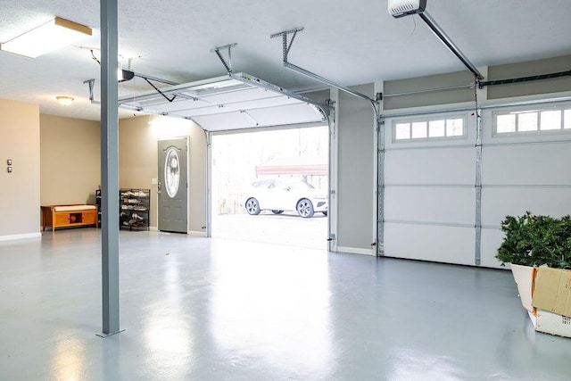 255 Hedgerow Cir, Auburn, AL 36830 - garage featuring baseboards and a garage door opener