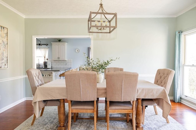 255 Hedgerow Cir, Auburn, AL 36830 - dining space with wood finished floors, crown molding, and a chandelier