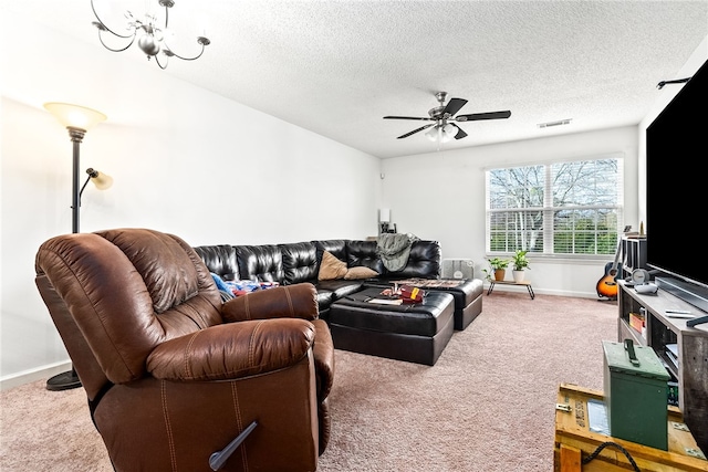 carpeted living room featuring ceiling fan and a textured ceiling