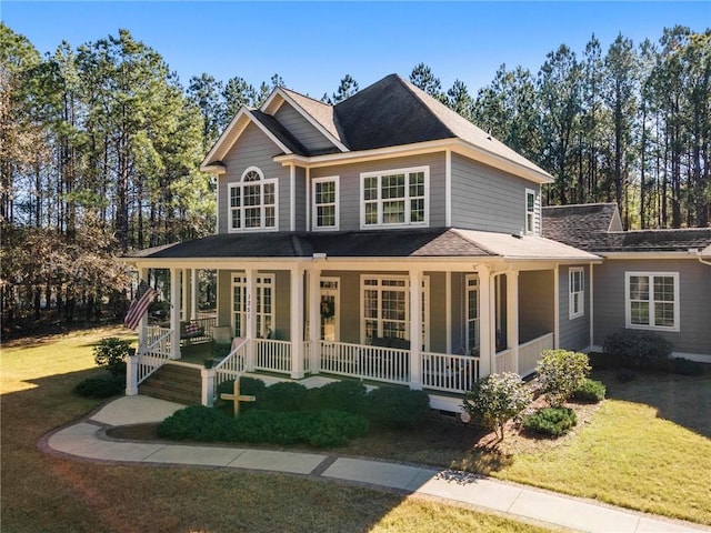 view of front facade featuring a front yard, covered porch, and french doors