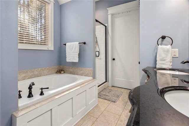 bathroom featuring tile patterned flooring, sink, and shower with separate bathtub