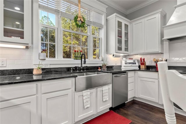 kitchen featuring premium range hood, white cabinetry, dark hardwood / wood-style flooring, ornamental molding, and stainless steel dishwasher