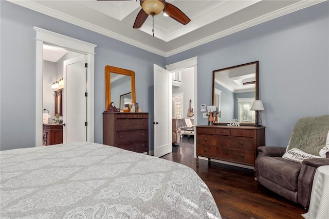 bedroom featuring ceiling fan, crown molding, a tray ceiling, connected bathroom, and dark hardwood / wood-style flooring