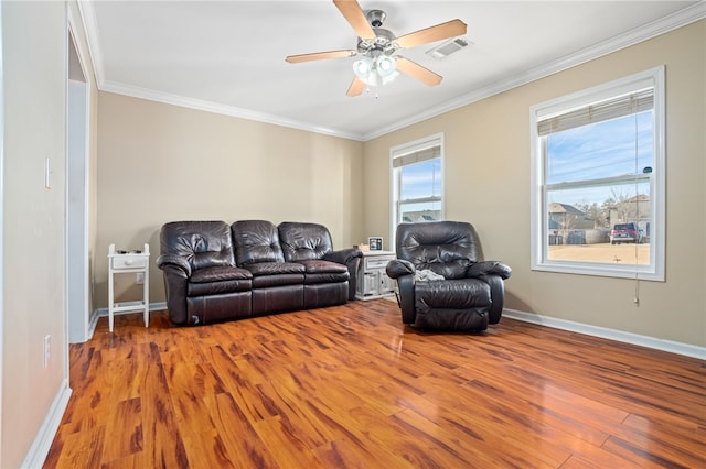 living room with hardwood / wood-style floors, ceiling fan, and ornamental molding