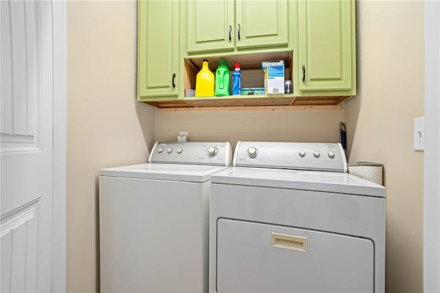 laundry room featuring cabinets and washing machine and dryer