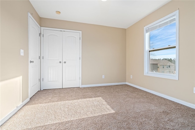 unfurnished bedroom featuring a closet and carpet floors