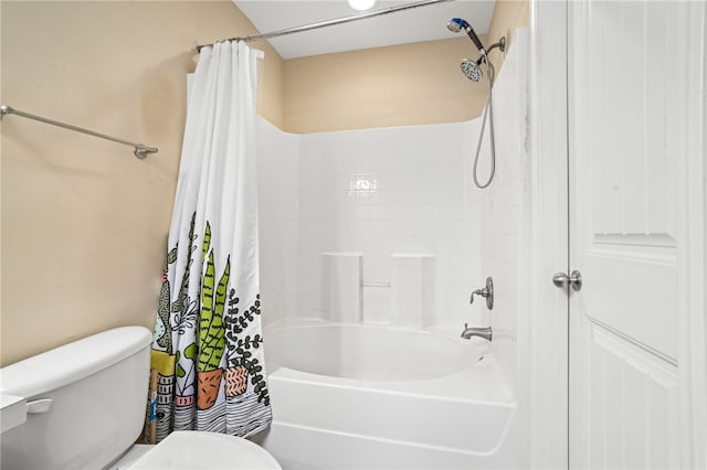 bathroom featuring shower / tub combo and toilet