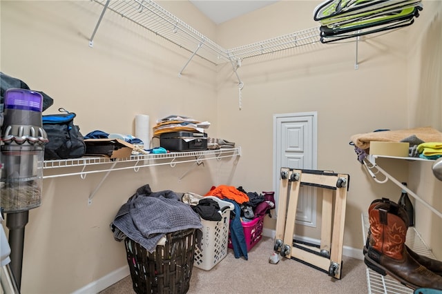 walk in closet with carpet