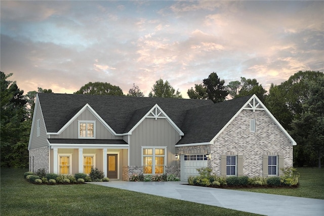 craftsman inspired home featuring a garage, a front yard, concrete driveway, and brick siding