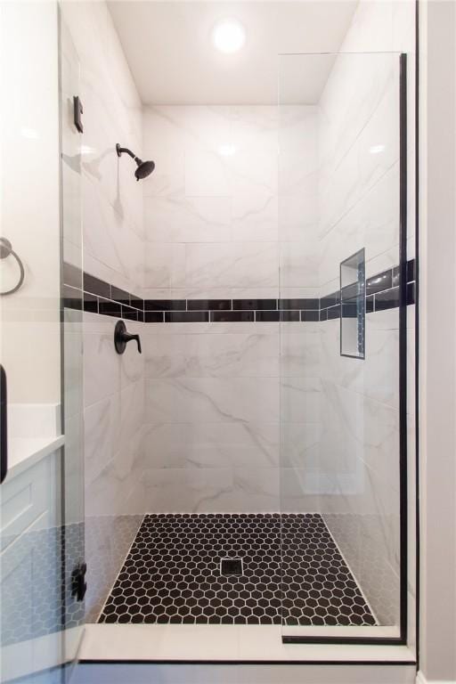 bathroom featuring a shower with shower door