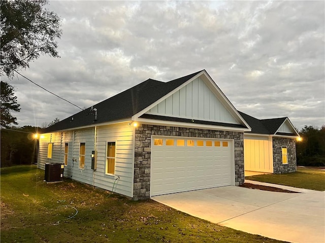 view of side of home featuring central AC and a garage