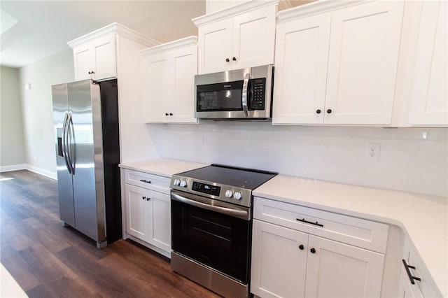 kitchen featuring tasteful backsplash, dark hardwood / wood-style flooring, white cabinets, and appliances with stainless steel finishes