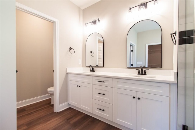 bathroom featuring wood-type flooring, vanity, and toilet