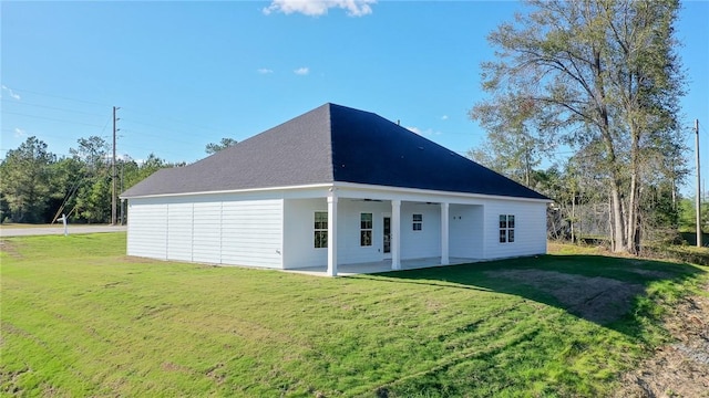 back of house featuring ceiling fan, a yard, and a patio