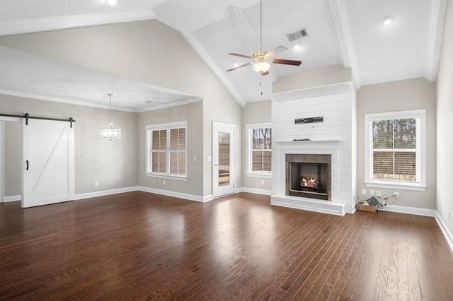 unfurnished living room featuring high vaulted ceiling, a fireplace, ceiling fan, a barn door, and dark wood-type flooring