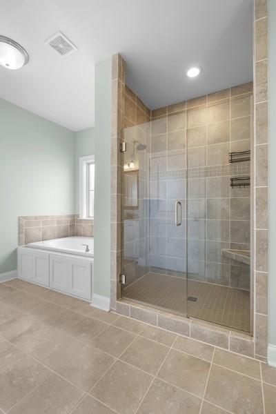 bathroom featuring separate shower and tub and tile patterned flooring